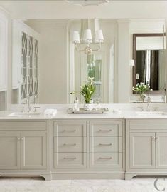 a large bathroom with double sinks and mirrors