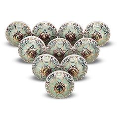 twelve decorative glass bowls with floral designs on them