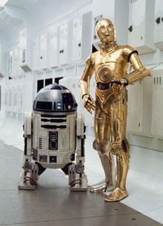 two star wars characters standing next to each other