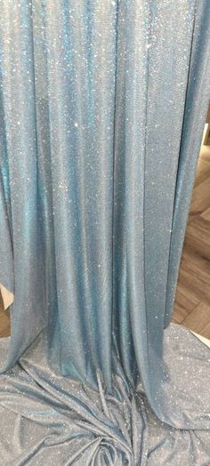 1mtr . baby blue Sparkly moonlight fabric 58 inches  wide  fabric. this is lovely beutifull elegant stretchy moonlight fabric can be used for bridal wear dresses party wear draping crafts and many other things. Mtr price.please note colour may be slightly different from photos due to lighting but it is a beautiful baby blue moonlight colour. Thank you Sparkly Blue Fabric, Moonlight Fabric Dresses, Light Blue Party Theme, Elegant Blue Sparkling Sequin Fabric, Light Blue Sparkly Dress, Blue Party Themes, Light Blue Decor, Baby Blue Fabric, Moonlight Dress