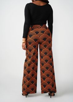 Style#: 4029/P4029 The Thema wide-leg African-print pants are an absolute #DiyanuTribe must! The bold Black Amber Dots print is paired with just the right amount of stretch for work or play and features a wide leg that's flattering on all. Features: Stretch Woven Wide Leg Pants Waist Band with Elastic 2 Side Pockets at Hip Fly Front Zipper with Hook and Eye Closure 72% Rayon/24% Nylon/4% Spandex Inseam: 33" Care Instructions: Use mild detergent. Do not bleach. Wash and iron inside out. Machine w Casual Wide Leg Pants With Bold Print, Retro Wide Leg Printed Bottoms, Patterned Wide Leg Printed Pants, Patterned Printed Wide Leg Pants, Non-stretch Black Retro Bottoms, Orange Printed Wide Leg Bottoms, Black Printed Wide Leg Pants, Printed Wide Leg Orange Bottoms, Black Wide Leg Printed Pants