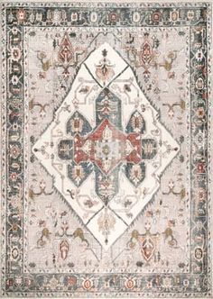 a rug with an ornate design on the front and back side, in grey tones