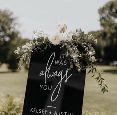 a sign that says it was always you and has flowers on the top with greenery