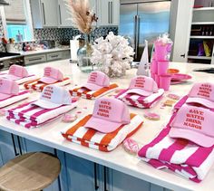 pink and orange hats are sitting on the kitchen counter