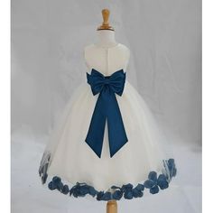 a white dress with blue flowers on the skirt