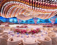 a large banquet hall with tables and chairs set up for a formal function at night