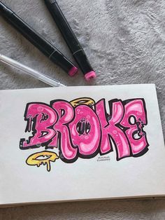 some writing on a piece of paper with marker pens next to it that says broke