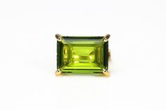 The unmistakable elegance of a Peridot stone is the highlight of this emerald cut ring. A gold birthstone ring for women born in August. This Peridot ring is fashionably versatile and has been perfectly crafted to suit your timeless style. ☛ 𝒜𝐵𝒞 - Add Engraving - https://etsy.me/2ZSRjhu ☛ Ring size - Select the size you would like from the drop down menu ♥ Gemstone Type - Peridot (Lab Created) ♥ Gemstone Size - 13x18mm ♥ Gemstone Cut - Rectangle ♥ Metal Type (Main Photo) - 14k Gold Filled - O Green Emerald Ring With Faceted Emerald Cut, Faceted Green Emerald Cut Emerald Ring, Green Faceted Emerald-cut Emerald Ring, Fine Jewelry Green Rings With Rectangular Stone, Green Ring With Rectangular Stone In Prong Setting, Green Rectangular Stone Ring With Prong Setting, Green Square Cut Rings With Accent Stones, Green Rectangular Solitaire Jewelry, Elegant Rectangular Peridot Rings