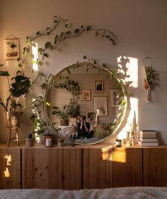 a woman taking a selfie in front of a mirror with plants on the wall