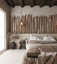 a large bed sitting in a bedroom next to a window with wooden sticks on the wall