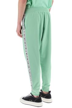 Dsquared2 track pants crafted in cotton and recycled polyester blend jersey. They feature elasticated waistband, side seam pockets, hem with elasticated cuffs and they're characterized by contrasting side bands with logo. Decorated with logo label on the fly. Relaxed fit. The model is 187 cm tall and wears size L. Size Info STANDARD Color Detail Green Made In Italy Material 55% PL 45% CO Season One spring Season Two summer Product clothing Brand Dsquared2 Size And Fit Trench Dress, Latest Fashion Design, Track Pant, Cape Coat, Logo Label, The Fly, Knitwear Cardigan, Cool Socks, Pant Shirt