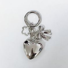 a silver heart shaped keychain on a white background