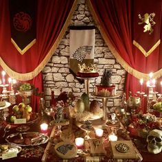 a table topped with lots of food and candles