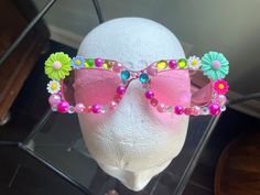 Add a little fun to any outfit with these flowery sunglasses. Fun Spring Festival Sunglasses, Playful Sunglasses For Party, Trendy Handmade Sunglasses For Party, Trendy Handmade Sunglasses For Parties, Fun Multicolor Spring Sunglasses, Fun Multicolor Sunglasses For Spring, Playful Multicolor Sunglasses For Spring, Chic Festival Sunglasses With Tinted Lenses, Chic Tinted Sunglasses For Festivals