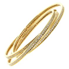 A magnificent Cartier "Trinity" bangle, 6.45ct of round brilliant cut diamonds grace the full length of each of these 18k Yellow Gold Trinity Bangles. The bracelet measures a size medium and will fit a wrist upto 7" Cartier Diamond Bracelet, Trinity Bracelet, White Gold Diamond Bracelet, Yellow Gold Bangle, Gold Armband, Bangle Bracelet Set, Diamond Bangles Bracelet, Bracelets Gold Diamond, Gold Diamond Necklace