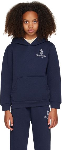 Garment-dyed cotton-blend fleece hoodie. · Pre-shrunk · Logo and text printed at chest · Kangaroo pocket · Rib knit hem and cuffs · Machine-wash Supplier color: Navy/White Model measures 55 / 139.7 cm tall and wears size 8-10Y. Size: child's height 2-4Y: 35.75-41.25 / 91-105 cm 4-6Y: 41.25-46.75 / 104.8-118.5 cm 6-8Y: 46.75-52.25 / 118.7-132.5 cm 8-10Y: 52.25-55.25 / 132.7-140.5 cm 10-12Y: 52.25-55.25 / 140.5-148.5 cm Navy Hoodie With Embroidered Logo For Fall, Navy Casual Hoodie With Embroidered Logo, Navy Hooded Sweatshirt With Embroidered Logo, Navy Embroidered Logo Hooded Sweatshirt, Navy Hoodie Sweatshirt With Embroidered Logo, Navy Cotton Hoodie With Ribbed Cuffs, Streetwear Hoodie With Pockets, Rich Kids, Sporty And Rich