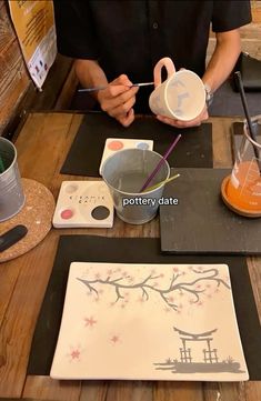 a person sitting at a table with various items on it