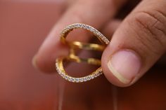 a close up of a person holding a ring