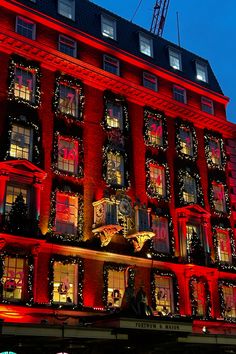 a large red building covered in christmas lights