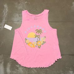 Billabong Pink Wide Strap Tank Girls Front Design. Front Features Beach Scene With Light Blue Billabong Lettering, Yellow Sunset With Olive Green Palm Trees And Yellow And Orange Hibiscus Flowers On Bottom. Wide Fit Tank With Ruffled Hem. Nwt Girls Size Medium / 10 Original $28 Measures 15.5 Inches Armpit To Armpit 18 Inches Across Bottom 20 Inches Top Of Shoulder To Bottom (Bottom Is Scooped So Longer And Shorter At Other Areas) 100% Cotton Fun Pink Tank Top For Beach, Playful Pink Tops For Beach Season, Fun Cotton Tank Top For Beach, Fun Cotton Tank Top For The Beach, Playful Pink Tops For Vacation, Playful Beach Tops, Playful Beach Season Tops, Playful Cotton Beach Tops, Playful Cotton Tops For Beach