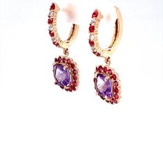 These cute and dainty Earrings have 2 Cushion Cut Amethysts that weigh 2.27 Carats and are embellished with 46 Round Cut Red and White Sapphires that weigh 1.56 Carats. The Total Carat weight of the Earrings are 3.83 Carats. The Earrings are about an 1.2 inches in length They are beautifully set in 14 Karat Rose Gold and weigh approximately 4.9 Grams.   Exact dimensions for this item are unknown. Please reach out in the seller Q&A for any questions on measurements. Formal Amethyst Jewelry For Valentine's Day, Purple Multi-stone Earrings For Anniversary, Elegant Purple Round Hoop Earrings, Yellow Gold Multi-stone Amethyst Earrings, Fine Jewelry Amethyst Earrings With Gemstone Accents, Multi-stone Earrings For Anniversary, Elegant Purple Gemstone Hoop Earrings, Formal Dangle Hoop Earrings With Gemstones, Purple Drop Earrings For Valentine's Day