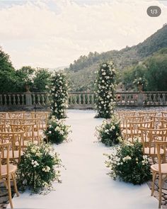 an outdoor ceremony set up with chairs and flowers