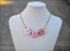 "Featuring three shade pink Roses centered necklace. Color Roses as seen in the picture are Pastel Blush, Powdery and Dusty Pink (from left to right). Varety pink shade combination can be seen as in the last picture, feel free to convo me or drop a note if you prefer different color . Material and size : - Hand Sculpted Clay Roses, size approximately 24-25mm. - Roses glued on the antiqued brass filigrees. - Cream Pearls - Antiqued brass cable chain (pictured). Silver Plated available. - Length o Color Roses, Three Roses, Trio Necklace, Pink Shade, Polymer Clay Necklace, Pearl Cream, Rose Necklace, Clay Necklace, Paper Jewelry