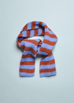 an orange and blue striped scarf laying on top of a table