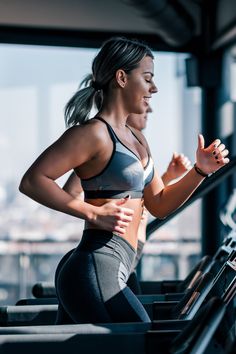 a woman is running on a treadmill