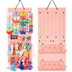 two pink wall hangings with bows and clips attached to the hooks on each side