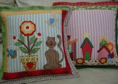 two decorative pillows with animals and flowers on them