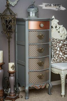 an antique dresser with many drawers and knobs on it's sides, next to a white chair