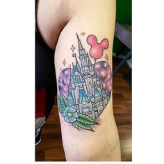 a disney castle tattoo on the right thigh