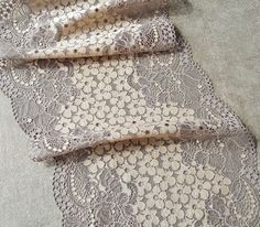 Taupe wide stretch lace trim with a pretty light beige floral design. It is an elastic lace with double flounce edges and is excellent quality with a soft handle and drape. This listing is for 1 METER = 1.09 yard width: 8.07 inch = 20.5 cm Ideal for sewing and craft projects. This stretch lace ideal for lingerie, bra making, clothing, accessories, doll dresses, table runner decoration, home textile, gifts, bags decoration, skirt bottoming, home decor and other projects you could imagine. Multipl Spring Scalloped Stretch Lace, Fitted Cream Lace With Patchwork Detail, Fitted Cream Lace With Lace Patchwork, Beige Crochet Lace For Spring, Spring Beige Crochet Lace, Cream Lace With Lace Trim For Spring, Beige Scalloped Lace For Spring, Fitted Beige Crochet Lace, Pretty Lights