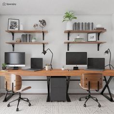 two computer desks with computers on them in front of bookshelves and shelves