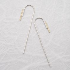 "This pair of minimalistic Arch threader earrings is shaped from a 0,9mm sterling silver wire and then soldered to a 1mm 18kt solid gold wire of 1cm and then brushed for a matte finish. Also available in a traditional shiny finish. They are perfect to complete any casual outfit, also the best gift for design lovers. This listing is for one pair of earrings. ------ HIGH QUALITY We create long lasting, timeless design jewelry handcrafted in Paris with loving attention to details. All AgJc jewelry Minimalist Silver Linear Earrings In Brass, Minimalist Hammered Sterling Silver Linear Earrings, Gold Minimalist Wrap Earrings In Sterling Silver, Gold Sterling Silver Minimalist Wrap Earrings, Minimalist Hand Forged Earrings, Minimalist Yellow Gold Linear Earrings In Sterling Silver, Gold Minimalist Threader Earrings In Sterling Silver, Gold Sterling Silver Minimalist Threader Earrings, Minimalist Long Drop Earrings With French Hook