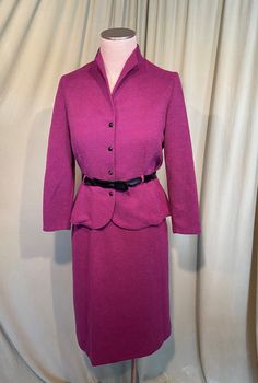 "This is a cute, vintage, 2 piece matching skirt set from early late 70s or early 80s but made in 40s style. No labels, but it does have a Union label & a care & content label. It is a skirt and a matching jacket in bubby textured polyester in raspberry purple. Tagged a size 12. Waist measures 28 to 34\", bust measures 34\", please see measurements below. The jacket has mid length sleeves & a slightly funnel neckline. It buttons up the front with 4 plastic buttons & the buttonhol Retro Fitted Skirt Suit For Spring, Retro Fitted Skirt Suit, Vintage Fitted Long Sleeve Skirt Suit, Vintage Fitted Skirt Suit With Long Sleeves, Vintage Fitted Skirt Suit For Fall, Fitted Vintage Skirt Suit With Long Sleeves, Retro Fitted Long Sleeve Skirt Suit, Retro Fitted Winter Skirt Suit, Retro Winter Fitted Skirt Suit