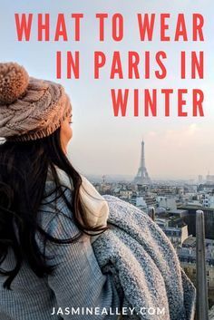 a woman looking at the eiffel tower in paris with text that reads, what to wear in paris in winter