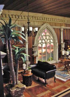 a living room filled with furniture and a large window covered in stained - glass windows