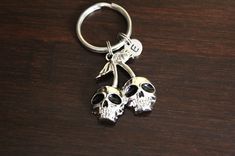 two skulls are attached to a key chain