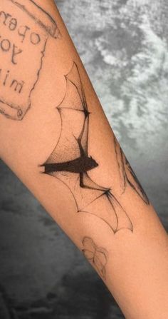 a person with a tattoo on their arm that says open your mind and an arrow