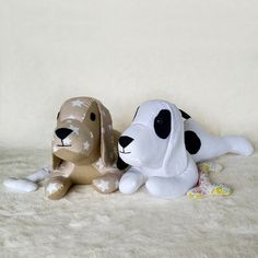 two small dogs sitting next to each other on a white surface with the words lazy dog written above them