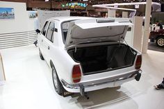 a white car with its trunk open on display