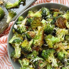 broccoli with shredded parmesan cheese in a bowl on a wooden table