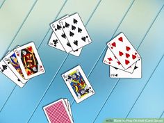 four playing cards are falling down in the air