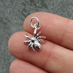 "This Spider Charm comes with a silver jump-ring as pictured. Please note that photo is not to scale and may appear larger to show detail. Refer to exact measurements below. Additional attachments (lobster clasp, large-hole bead, necklace chains) are available from the charm-attachments drop-down menu.  For a visual example of the different attachments and what each one is best suited for, scroll through the photos until you see the example photo or visit https://etsy.me/2BY7DAW for detailed information.    { DETAILS } ★ Material: Sterling Silver  ★ Finish Color: Silver  ★ Measurements: 3/8\" x 1/2\" ★ Dimensions: 3-Dimensional ★ Made in the USA { SIMILAR ITEMS }  More Halloween themed items available from my shop: https://www.etsy.com/shop/treasuredcharms/search?search_query=halloween { G Silver Novelty Jewelry With Lobster Clasp, Novelty Silver Pendant Jewelry, Silver Themed Pendant Jewelry, Themed Silver Pendant Jewelry, Nickel-free Silver Novelty Charms, Tiny Silver Charms For Gifts, Halloween Silver Charm Jewelry, Silver Halloween Charms Jewelry, Silver Halloween Jewelry With Charms