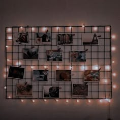 a wall mounted with pictures and lights in the shape of a grid on top of it