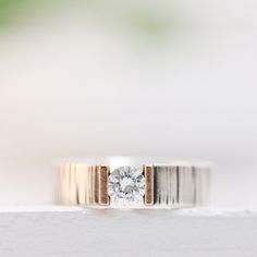 a close up of a ring with a diamond on it