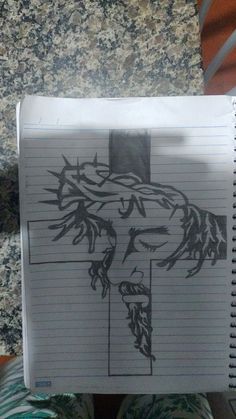 a notepad with a drawing of jesus on it