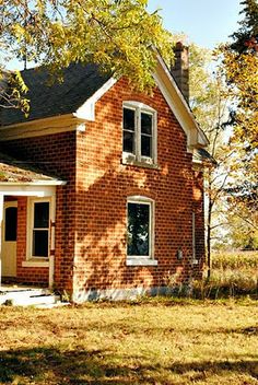 an old red brick house in the fall